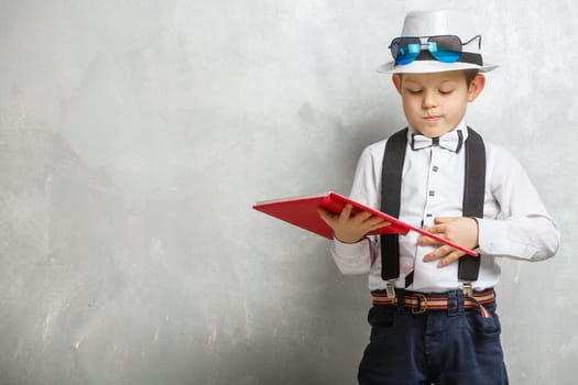 boy holding book on gray background for education concept.