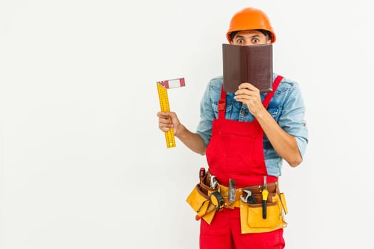 Portrait of cheerful young worker wearing hardhat over white background.