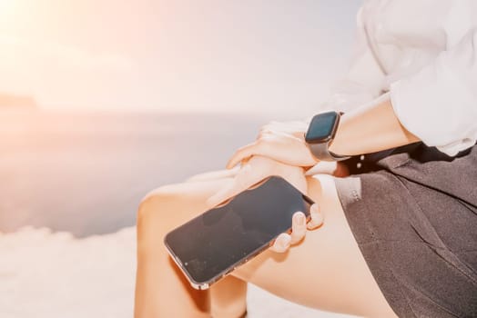 Happy girl doing yoga with laptop working at the beach. beautiful and calm business woman sitting with a laptop in a summer cafe in the lotus position meditating and relaxing. freelance girl remote work beach paradise