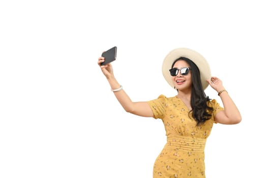 Image of pretty young woman dressed in summer clothes making selfie on smartphone isolated on white background.