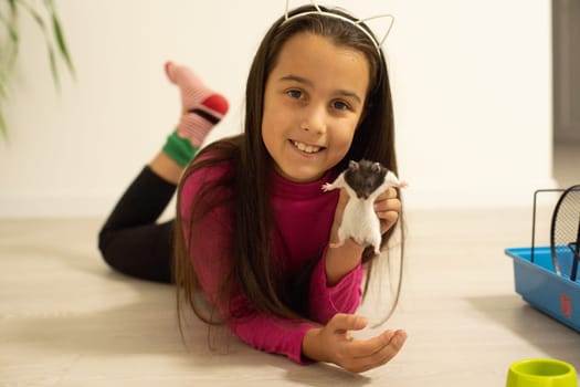 little girl holding a hamster