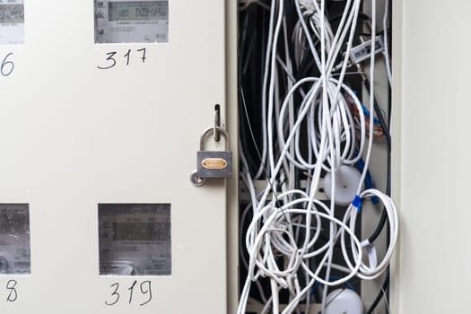 Electric cabinet with Internet and television cables in an apartment building. Niche for wires and cables inside the wall.