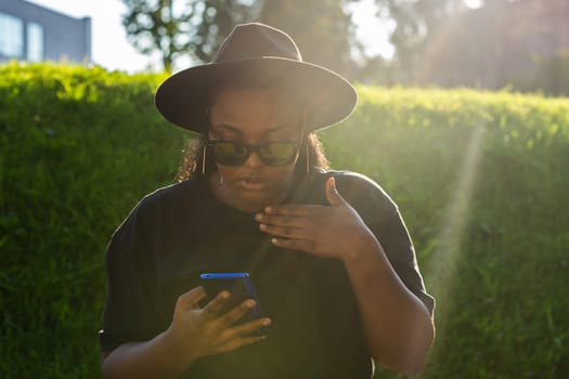 African american woman talking phone in the city - communication