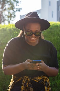 African american woman talking phone in the city - communication