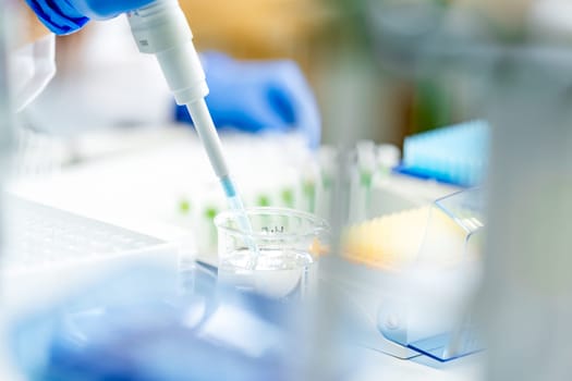 conducting chemical research in a research laboratory. pipetting the sample into glass flasks.