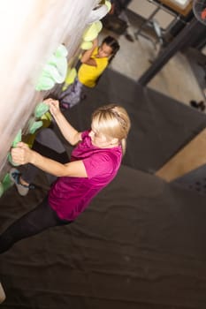 mother and daughter climb on the climbing wall. Family sport, healthy lifestyle, happy family.