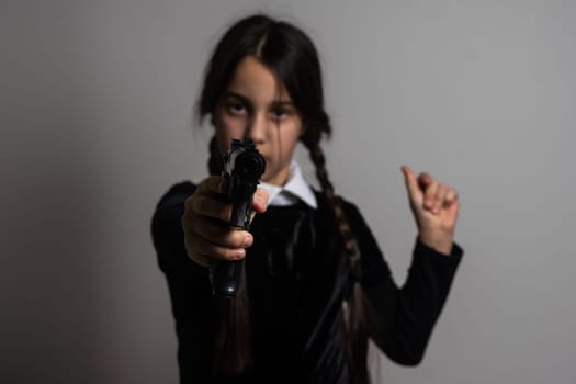Wednesday Addams. Gothic girl with pistol, weapon.