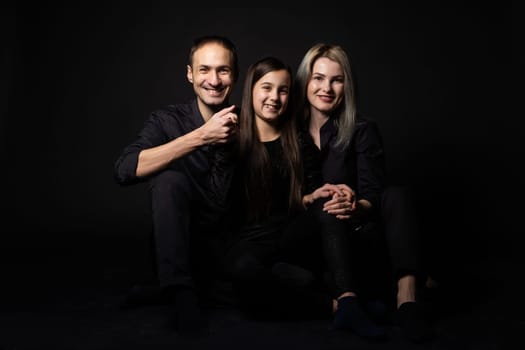 Family portrait on black background.