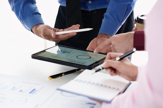 Close up of Diverse colleagues gather brainstorm discuss financial statistics at office meeting. finance, teamwork, Big data Graphs Charts concept.