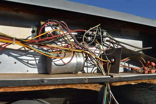 Mess of Wires in Rooftop Air Conditioner Repair . High quality photo