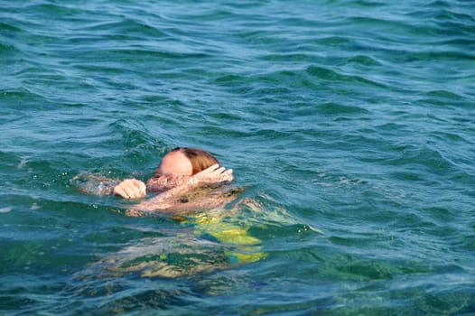 drowning choking girl in the sea close up.