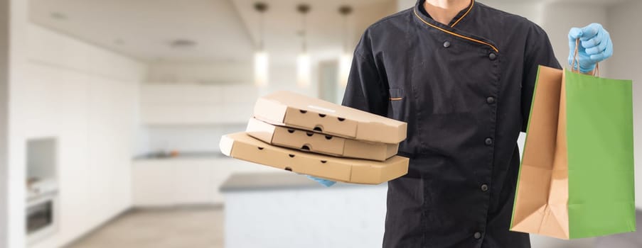 Young handsome delivery man holding paper bag with takeaway food happy with big smile