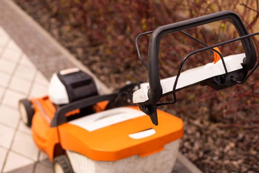 Automatic lawnmower in modern garden.