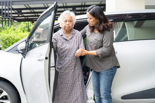 Asian senior woman patient sitting on walker prepare get to her car, healthy strong medical concept.