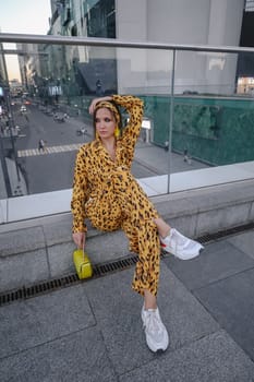 A portrait of a fashion-dressed happy woman posing for a photo shoot on the streets