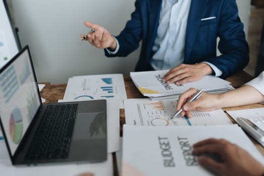 Asian business advisor meeting to analyze and discuss the situation on the financial report in the meeting room.Investment Consultant, Financial , teamwork ,brainstorming ,startup and accounting.