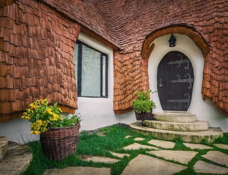 The Clay Castle from the Valley of Fairies, a touristic complex in Transylvania, Romania. Closeup view to a tiny entrance door, fantasy dwarf house from tales