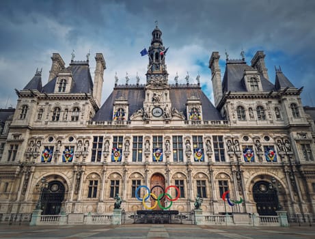Paris City Hall, France. Outdoors view to the beautiful ornate facade of the historical building and the olympic games rings symbol in front of the central doors