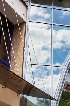 Reflecting clouds in mirrored windows of themodern building