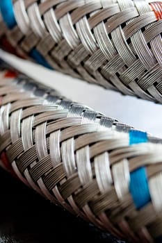 Metal water pipes on a wooden table, macro photo