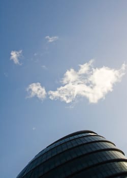 London, United Kingdom - December 03, 2006: Small cloud over roof of City Hall, headquarters of Mayor, designed by Norman Foster. Example of modern architecture in UK capital