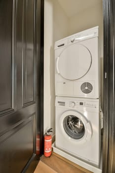 a laundry room with a washer and dryer next to the door that has been painted in black on it