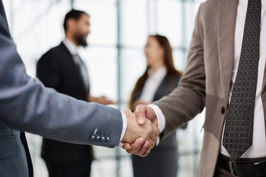 Nice to meet you. Close-up of two young businessmen shaking hands