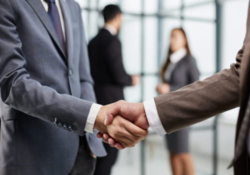 Nice to meet you. Close-up of two young businessmen shaking hands