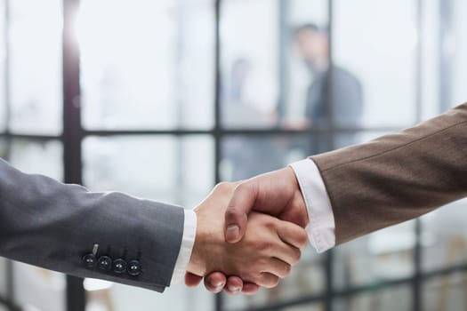 Nice to meet you. Close-up of two young businessmen shaking hands