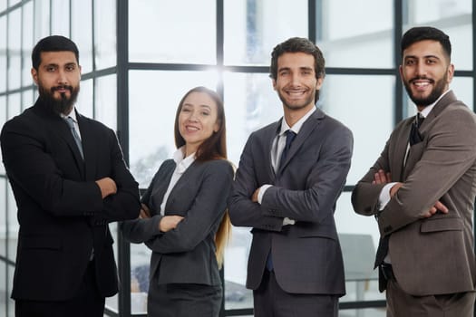 Portrait, collaboration and diversity with a business team standing arms crossed together in their office.