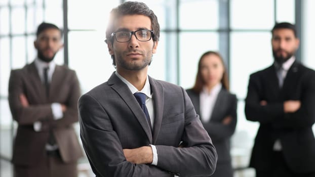 company workers standing in a row in creative office, posing on camera