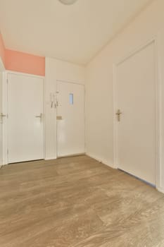 an empty room with wooden floors and white doors on either side of the room, there is no one door