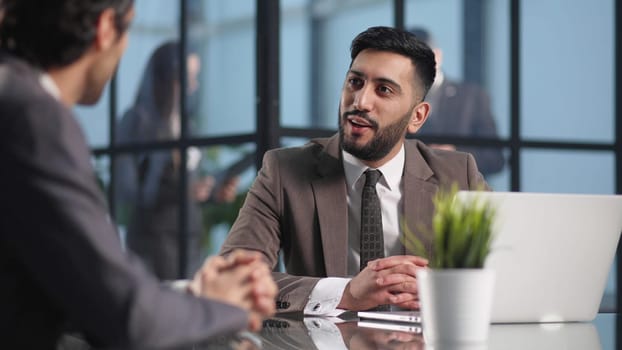Shot of two young male having a conversation in a modern office.