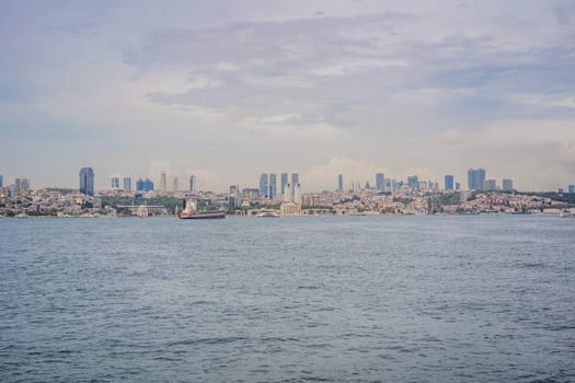 Istanbul at sunset, Turkey. Tourist boat sails on Golden Horn in summer. Beautiful sunny view of Istanbul waterfront with old mosque. Concept of travel, tourism and vacation in Istanbul and Turkey. Turkiye.