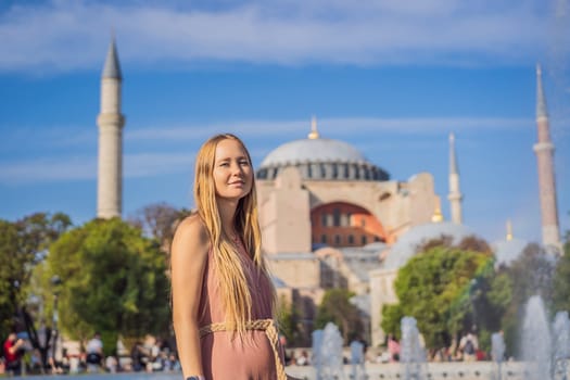 Woman enjoy beautiful view on Hagia Sophia Cathedral, famous islamic Landmark mosque, Travel to Istanbul, Turkey. Sunny day architecture and Hagia Sophia Museum, in Eminonu, istanbul, Turkey. Turkiye.