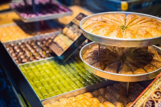 Traditional oriental sweet pastry cookies, nuts, dried fruits, pastilles, marmalade, Turkish desert with sugar, honey and pistachio, in display at a street food market.