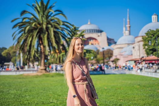 Woman enjoy beautiful view on Hagia Sophia Cathedral, famous islamic Landmark mosque, Travel to Istanbul, Turkey. Sunny day architecture and Hagia Sophia Museum, in Eminonu, istanbul, Turkey. Turkiye.