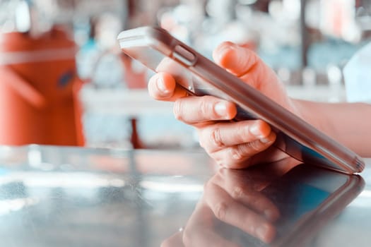 Close up shot of a woman using a mobile phone in a cafe