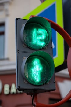 Green light on a pedestrian traffic light. Safe crossing of the road by pedestrians.