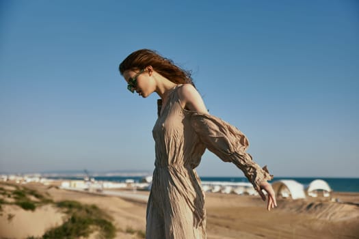 horizontal portrait of a slim woman in sunglasses against a blue sky. High quality photo