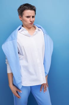 energetic charismatic short-haired lady in a casual shirt makes a grimace.