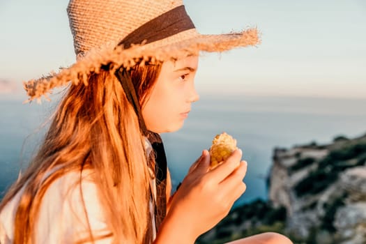 Portrait of young beautiful girl eating corn. Snacking on the sea