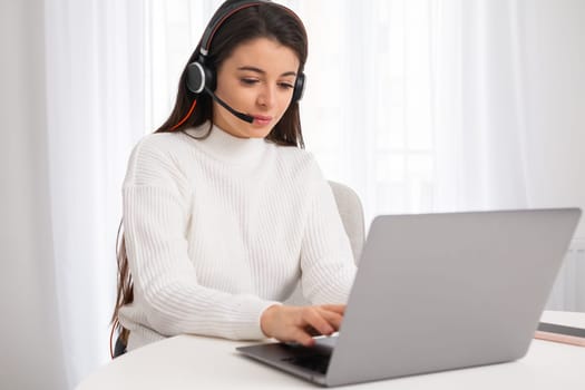 Call center agent in headset has a call via internet. Female customer support