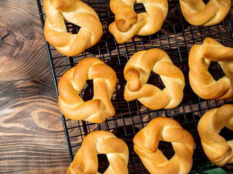 Taralli twist on wooden background. Typical italian ring-shaped or doughnut-shaped biscuit cookies or appetizers for wine Taralli or Taralle. Top view or flat lay. Copy space