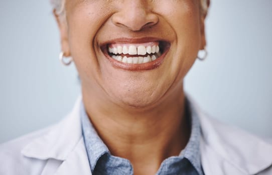 Dental, smile and elderly woman in studio for mouth, hygiene and denture care against grey background. Teeth whitening, cleaning and senior lady happy for oral, tooth and natural looking veneers.