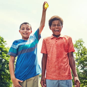 Do it, Im ready. adorable young boys playing with water balloons outdoors