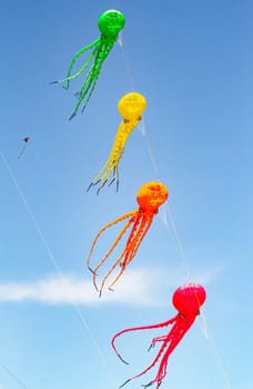 Blue sky with colorful kites in the shape of marine animal