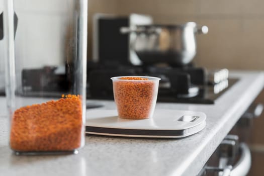 Making lentil soup puree starts by weighing the exact weight of the lentils on a kitchen scale.