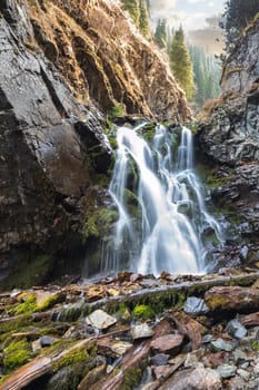 Ayusai waterfall 2 in Bear gorge of Almaty mountains, picturesque nature of Kazakhstan, vertical.