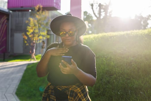 African american woman talking phone in the city - communication